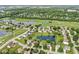 This aerial view showcases a charming home nestled in a lush neighborhood with a pond and golf course views at 4818 Arabian Run, Indianapolis, IN 46228