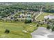 This aerial view showcases a cozy home nestled on a golf course with serene water views at 4818 Arabian Run, Indianapolis, IN 46228