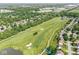 An aerial view showcasing a charming home nestled near a golf course with mature trees and greenery at 4818 Arabian Run, Indianapolis, IN 46228