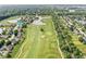 This aerial view displays a home nestled on a golf course with tranquil water views at 4818 Arabian Run, Indianapolis, IN 46228