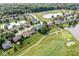 This aerial view highlights a cozy home on a golf course near a pond in a peaceful neighborhood at 4818 Arabian Run, Indianapolis, IN 46228
