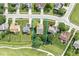 This aerial view shows a well-maintained home with a spacious yard adjacent to a lush golf course at 4818 Arabian Run, Indianapolis, IN 46228