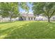 Spacious backyard featuring lush green grass, mature trees, and a fenced perimeter at 4818 Arabian Run, Indianapolis, IN 46228