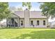 Manicured backyard with a screened porch and a patio, perfect for outdoor entertaining at 4818 Arabian Run, Indianapolis, IN 46228