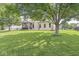 Expansive backyard with a well-maintained lawn, a patio, and a screened porch at 4818 Arabian Run, Indianapolis, IN 46228