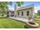 Backyard with a patio, fire pit, rocking chairs and a view of mature trees and lush green grass at 4818 Arabian Run, Indianapolis, IN 46228