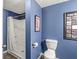 Bathroom featuring a shower, toilet, and Beatles-themed decor for a fun and stylish space at 4818 Arabian Run, Indianapolis, IN 46228