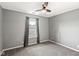 Bedroom featuring a window with curtains, a ceiling fan, and neutral walls at 4818 Arabian Run, Indianapolis, IN 46228