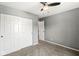 Neutral bedroom with closet, ceiling fan, carpet, and a view to another room at 4818 Arabian Run, Indianapolis, IN 46228