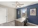 Bedroom with blue accent wall, a desk under the window, and framed art at 4818 Arabian Run, Indianapolis, IN 46228