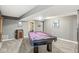 Billiard room featuring a purple felt pool table, vintage decor, and cozy lighting for a recreational space at 4818 Arabian Run, Indianapolis, IN 46228