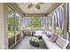 A comfortable covered patio with stylish curtains and cushioned seating, perfect for outdoor relaxation and entertaining at 4818 Arabian Run, Indianapolis, IN 46228