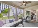 Relaxing covered patio with comfortable seating, ceiling fan, string lights and easy access to the dining area at 4818 Arabian Run, Indianapolis, IN 46228