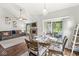 An open concept dining area adjacent to living room features hardwood floors, slider doors and stylish decor at 4818 Arabian Run, Indianapolis, IN 46228