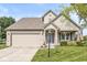 Charming two-story home with a well-manicured lawn, brick accents, and an attached two-car garage at 4818 Arabian Run, Indianapolis, IN 46228