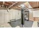 Unfinished basement gym with exposed beams, punching bag, elliptical, and weight equipment for a fitness area at 4818 Arabian Run, Indianapolis, IN 46228