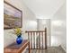 Bright hallway with wooden railing, leading to a sunlit entryway with double doors at 4818 Arabian Run, Indianapolis, IN 46228