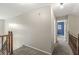 Hallway with neutral walls and carpet, opening to a bedroom with a blue accent wall at 4818 Arabian Run, Indianapolis, IN 46228