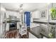 Well-lit kitchen with white cabinets, dark countertops, and stainless steel appliances at 4818 Arabian Run, Indianapolis, IN 46228