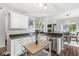 Bright kitchen with white cabinetry, stainless steel appliances, and dark countertops at 4818 Arabian Run, Indianapolis, IN 46228
