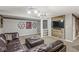 Relaxing living room with leather sectional, wooden wall decor, and sports memorabilia for a cozy gathering at 4818 Arabian Run, Indianapolis, IN 46228