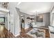 Stylish living room with hardwood floors, neutral decor, and view into the kitchen area at 4818 Arabian Run, Indianapolis, IN 46228