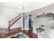 Comfortable living room featuring dark wood floors, a staircase and view of the kitchen at 4818 Arabian Run, Indianapolis, IN 46228