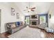 Bright living room with a brick fireplace, ceiling fan, and comfortable seating with plenty of natural light at 4818 Arabian Run, Indianapolis, IN 46228