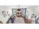 An elevated view of the living room with hardwood floors, fireplace and adjacent dining area with natural lighting at 4818 Arabian Run, Indianapolis, IN 46228