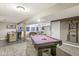 Spacious recreation room including a billiard table, wet bar, and living area, for relaxation and entertainment at 4818 Arabian Run, Indianapolis, IN 46228