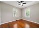 Bright bedroom with hardwood floors, neutral walls and trim, and natural light from two windows at 5232 E 10Th St, Indianapolis, IN 46219