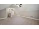 Spacious carpeted bonus room with two ceiling fans and natural light at 5232 E 10Th St, Indianapolis, IN 46219