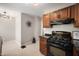 Contemporary kitchen featuring dark cabinetry, modern appliances, and tiled flooring at 5232 E 10Th St, Indianapolis, IN 46219