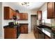 Bright kitchen with dark wood cabinets, modern appliances, and stylish light fixtures at 5232 E 10Th St, Indianapolis, IN 46219