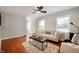 Cozy living room with hardwood floors, modern furniture, a ceiling fan and ample natural light at 5232 E 10Th St, Indianapolis, IN 46219