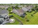 Aerial view of the backyard with a well-kept lawn and patio with outdoor seating and a firepit at 5560 Goodwin St, Indianapolis, IN 46234