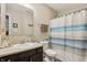 Bright bathroom features a tiled backsplash, modern fixtures, and a shower with curtain at 5560 Goodwin St, Indianapolis, IN 46234