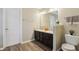 The bathroom features a double vanity, dark cabinets, wood-look floors, and a toilet at 5560 Goodwin St, Indianapolis, IN 46234