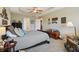 The spacious bedroom has a tray ceiling, a ceiling fan, carpet floors, and decorative wall art at 5560 Goodwin St, Indianapolis, IN 46234