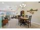 Bright dining area featuring a vaulted ceiling, chandelier, and an open floorplan to the living room at 5560 Goodwin St, Indianapolis, IN 46234