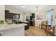 Well-equipped kitchen boasting stainless steel appliances, dark cabinetry, and a breakfast nook near the window at 5560 Goodwin St, Indianapolis, IN 46234