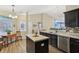 Bright kitchen with a center island, stainless steel appliances, and modern fixtures at 5560 Goodwin St, Indianapolis, IN 46234