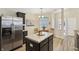Spacious kitchen features stainless steel refrigerator and center island with room for seating at 5560 Goodwin St, Indianapolis, IN 46234