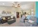 Spacious living room with plush sofas, a ceiling fan, and an adjoining dining area with an open floorplan at 5560 Goodwin St, Indianapolis, IN 46234