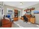 Home office is well-lit with built-in shelving, perfect for a productive workspace at 5560 Goodwin St, Indianapolis, IN 46234