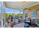 Cozy screened porch with seating, plants, and a view of the backyard at 5560 Goodwin St, Indianapolis, IN 46234