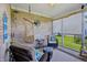 Screened-in porch featuring brick walls, comfortable seating, and open views at 5560 Goodwin St, Indianapolis, IN 46234