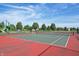 Outdoor tennis court with a green playing surface, set in a community recreation area with fencing at 5560 Goodwin St, Indianapolis, IN 46234