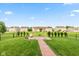 Landscaped backyard featuring a charming pergola, lush lawn, and privacy fence at 5891 Mimosa Dr, Indianapolis, IN 46234
