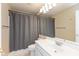 Bathroom featuring a large mirror, toilet, and shower with gray curtain at 5891 Mimosa Dr, Indianapolis, IN 46234